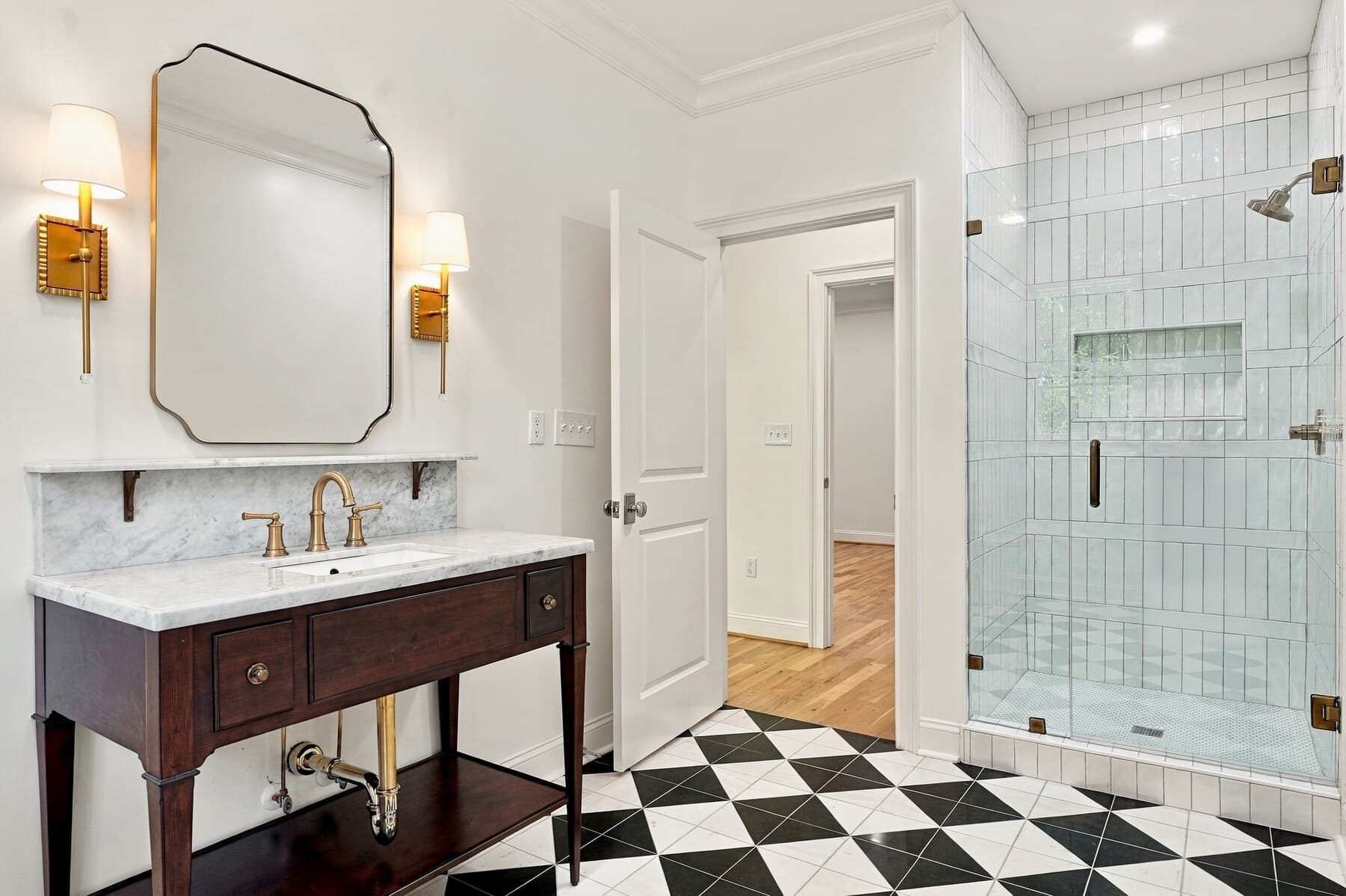 A renovated bathroom with checkerboard tile floor